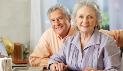 Two individuals maximizing their Social Security benefits by reviewing a document together.