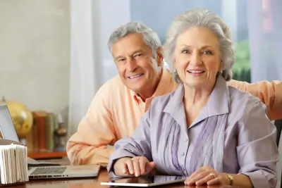 Two individuals maximizing their Social Security benefits by reviewing a document together.