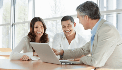 Three individuals with obscured faces are engaged in a discussion around a laptop, possibly regarding federal disability work processes.