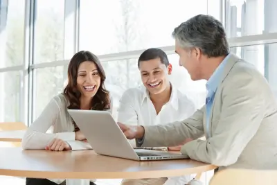 Three individuals with obscured faces are engaged in a discussion around a laptop, possibly regarding federal disability work processes.