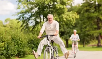 Happy retired couple biking outdoors, enjoying FERS benefits for a secure retirement.