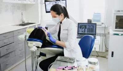 Dental professional performing a procedure on a patient, highlighting the benefits of FEDVIP through BENEFEDS.