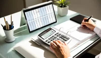 Professional calculating a FERS pension on a desk with tools.