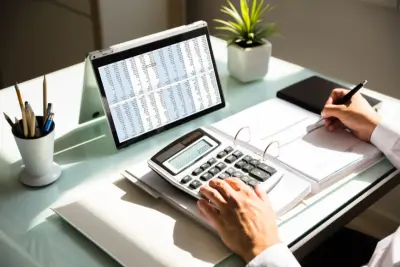 Professional calculating a FERS pension on a desk with tools.