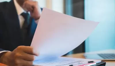 Professional reviewing documents for a federal employee benefit review.