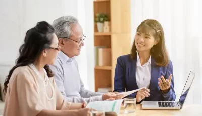 Advisor explaining federal employee retirement benefits to a couple.