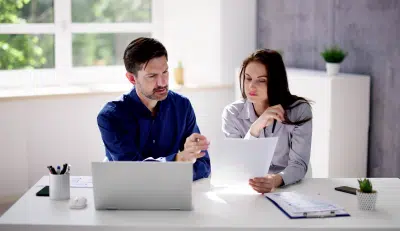 Couple reviewing social security for spouse documents at home
