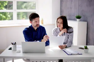 Couple reviewing social security for spouse documents at home