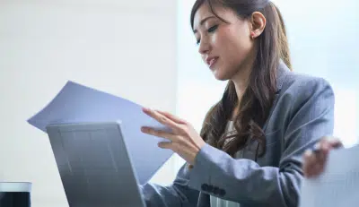 Federal Employee reviewing documents about the advantage of Roth IRA.