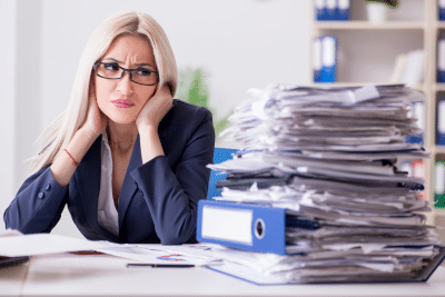 Stressed woman reviewing documents on whether an inherited IRA is taxable.