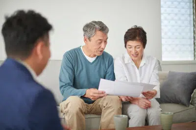Retired couple reviewing documents about their required RMD.