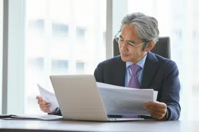 Senior man reviews documents about upcoming FEHB plan changes