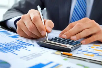 Man using calculator on charts for FERS retirement calculator planning