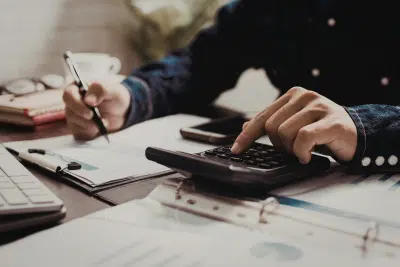 Person calculating numbers for a TSP Roth conversion strategy