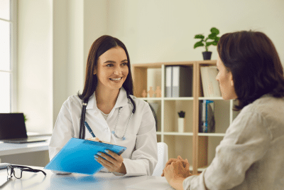 Doctor explains federal health insurance coverage to patient in office
